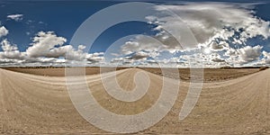 spherical 360 hdri panorama on gravel road with clouds and sun on blue sky in equirectangular seamless projection, use as sky