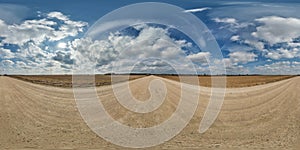 spherical 360 hdri panorama on gravel road with clouds and sun on blue sky in equirectangular seamless projection, use as sky