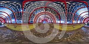 Spherical night 360 panorama in festively lit underground passage tunnel with red frame arch and transparent dome and concrete