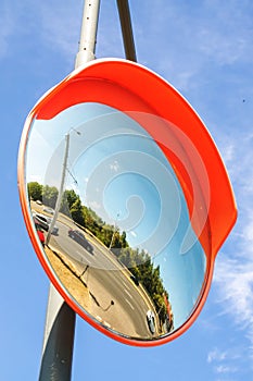 Spherical Road Mirror on blue sky background