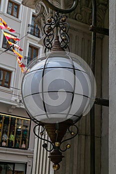 Spherical vintage lamp beside the wall