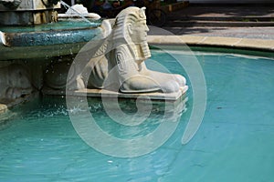 Sphinx, fountain with sphinxes, and blue water.