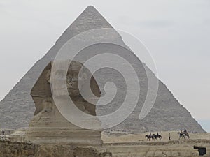 Sphinx in front of Pyramid in Egypt. Giza pyramid complex