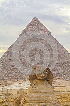 Sphinx sculpture and the Cheops pyramid in Giza Egypt