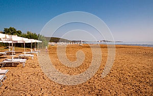 Spiaggia di Portonuovo beach and in background on chalky rocks the oldtown of Vieste and the monolite Pizzomunno