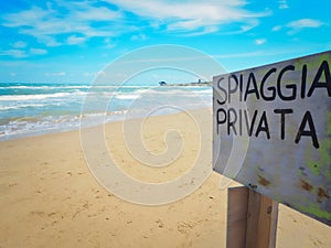 Spiaggia Privata translation Private Beach sign on the beach.