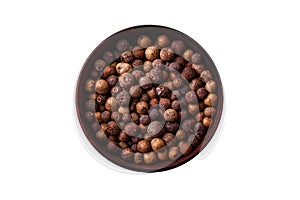 Spice allspice brown color not ground in a wooden saucer. Asian food