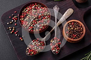 Spice allspice of different colors pink, white, green not ground in a wooden saucer