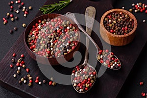 Spice allspice of different colors pink, white, green not ground in a wooden saucer