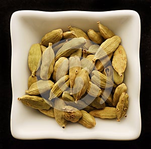 Spice cardamom in a ceramic bowl.