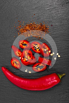 Spice in cooking red chili pepper on black stone