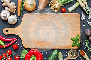 Spice herbs and vegetables food background and empty cutting board