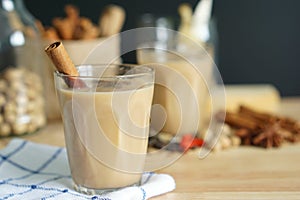 Spice milk tea or Indian masala chai and blurred various spices background