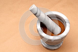 Spice in a mortar and pestle on brown