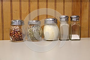 Spice Shakers at an Italian Restaurant, red pepper, oregano, parmesan, pepper, salt