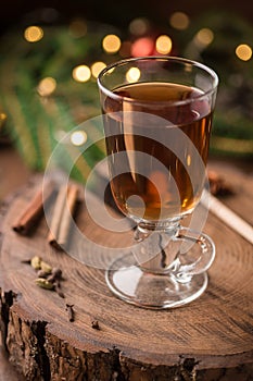 Spiced Apple Cider Mulled Sangria in glass cup on wooden background. Hot drinks for Christmas.