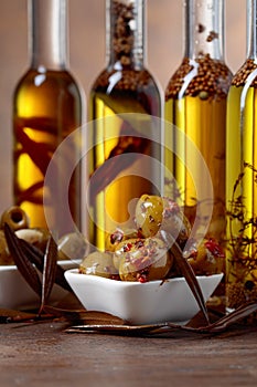 Spiced green olives and bottles with olive oil .