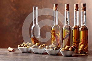 Spiced green olives and bottles with olive oil .