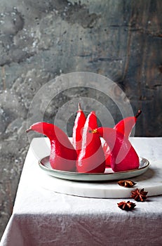 Spiced hibiscus or red wine poached pears. Delicious winter french dessert.