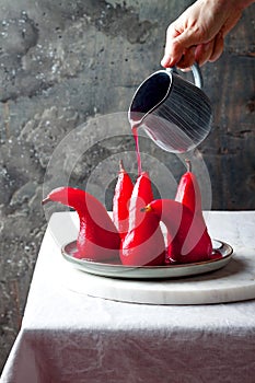 Spiced hibiscus or red wine poached pears. Delicious winter french dessert.