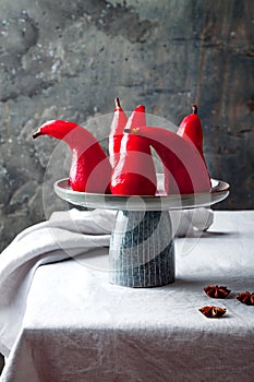 Spiced hibiscus or red wine poached pears. Delicious winter french dessert.