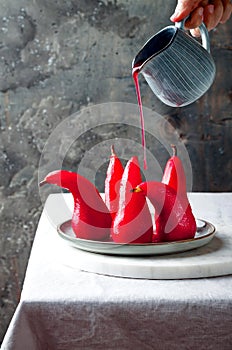 Spiced hibiscus or red wine poached pears. Delicious winter french dessert.