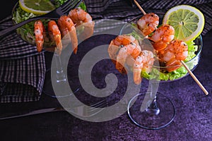 Spiced Prawn cocktail starter served in a tropical tourist restaurant in a glass with decoration of prawn with sprinkle of dill