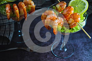 Spiced seafood Shrimp cocktail starter served in a tropical tourist restaurant in a glass with decoration of prawn with sprinkle