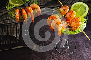 Spiced Shrimp cocktail starter served in a tropical tourist restaurant in a glass with decoration of prawn with sprinkle of dill,