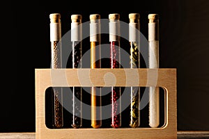 Spices in beakers on wooden table