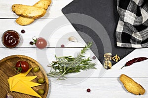 Spices and condiments, vegetables, cheese on wooden white background