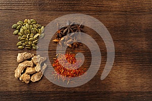 Spices on dark wooden background, view from above