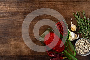 Spices on dark wooden background, view from above