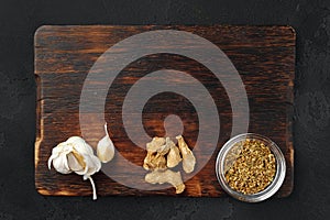 Spices on dark wooden background, view from above