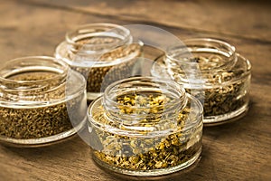 Spices and herbal tea ingredients on glass jars