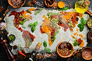 Spices and herbs around the world in the shape of a world map on a dark background.