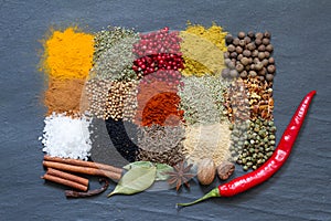 Spices and herbs on black marble abstract background