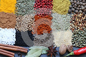 Spices and herbs on black marble abstract background