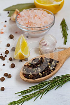Spices and herbs. close-up mix of peppers in a wooden spoon and Pink Himalayan salt