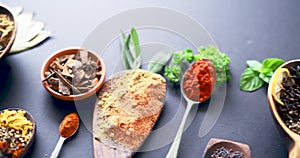 Spices, herbs and condiment for kitchen, layout and table for curry, wooden spoons and advertising. Food, natural or