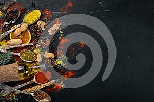 Spices and herbs. A large assortment of spices. Indian cuisine. On the wooden table.