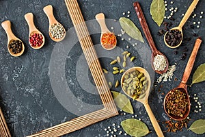 Spices and herbs over black stone background