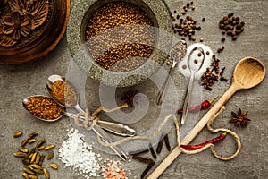 Spices and herbs over black stone background. Top view with free space for text.