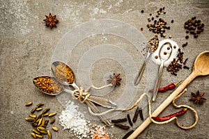 Spices and herbs over black stone background. Top view with free space for text.