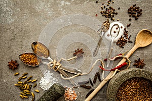 Spices and herbs over black stone background. Top view with free space for text.
