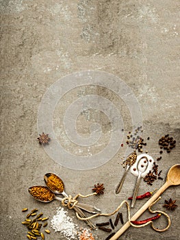Spices and herbs over black stone background. Top view with free space for text. Banner