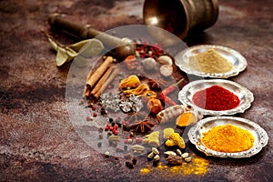 Spices and herbs in silver bowls