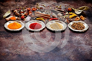 Spices and herbs in silver bowls