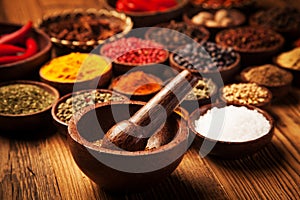 Spices and herbs in wooden bowls.