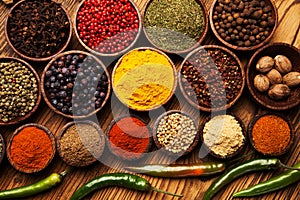 Spices and herbs in wooden bowls.